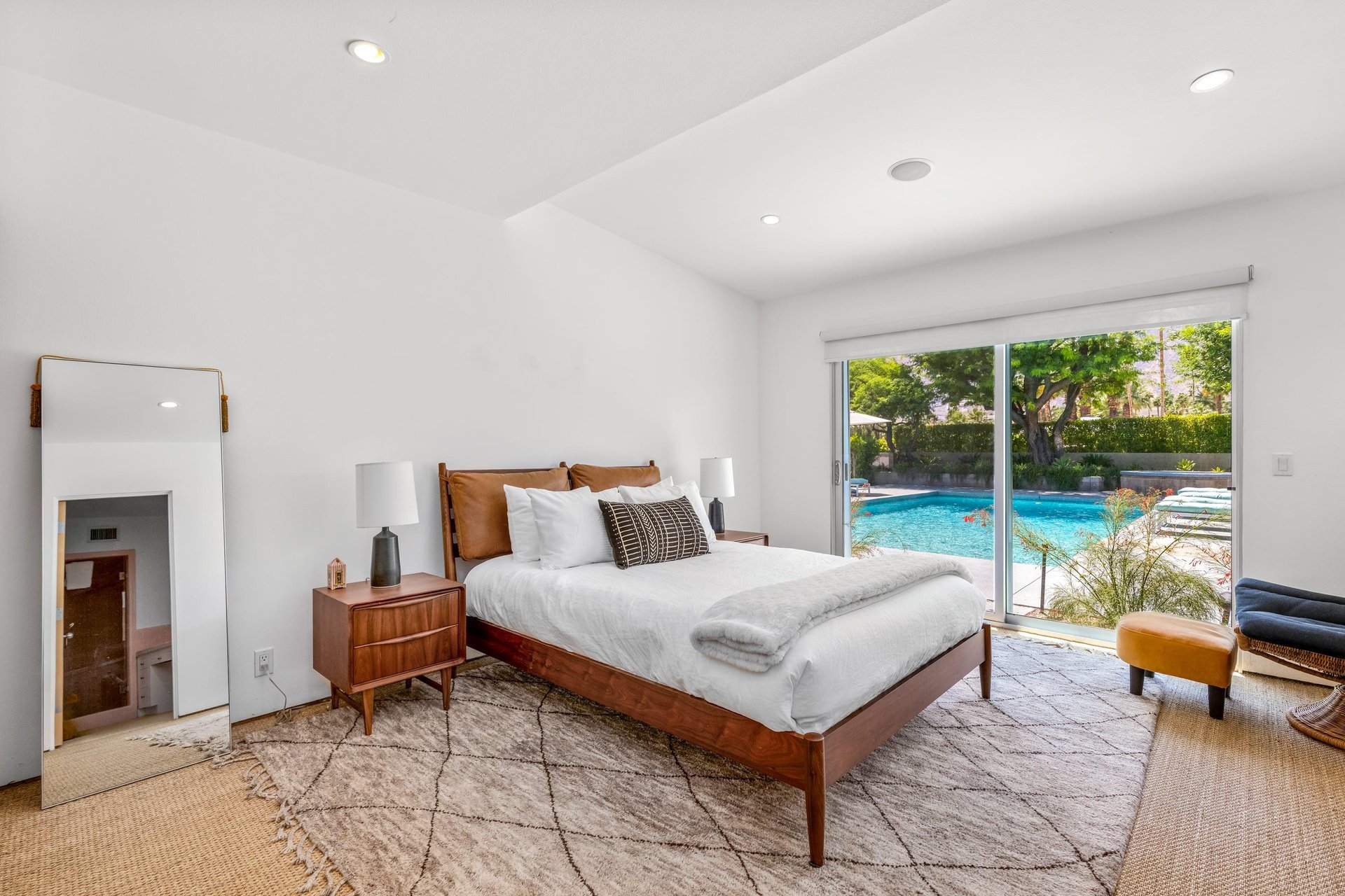 Features a queen bed, sliding doors to poolspa and patio, and ensuite bathroom.