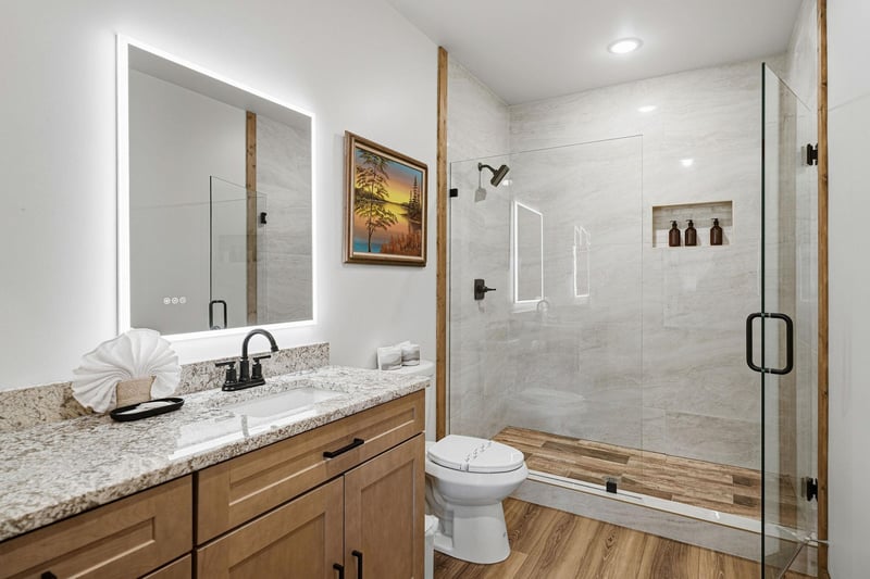 Unwind in your spalike bathroom with luxurious marble shower, granite countertops, and warm wood touches creating the perfect retreat.