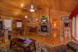 Living room with fireplace  TV at A Beary Cozy Escape, a 1 bedroom cabin rental located in Pigeon Forge