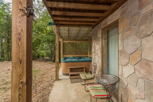 Patio with chairs and hot tub at Birds Eye View, a 2bedroom cabin rental located in Gatlinburg