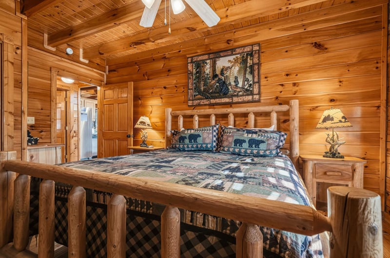 Nestle into your rustic cabin bedroom where handcrafted log furniture, warm wood walls, and wildlifethemed décor create a cozy mountain retreat perfect for peaceful nights.