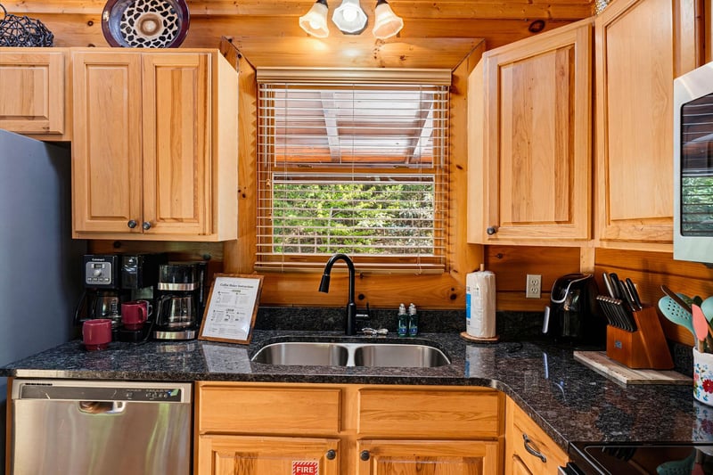 Step into your fully equipped kitchen, where warm wood cabinetry and granite counters invite you to brew morning coffee or prepare a hearty meal with your loved ones.