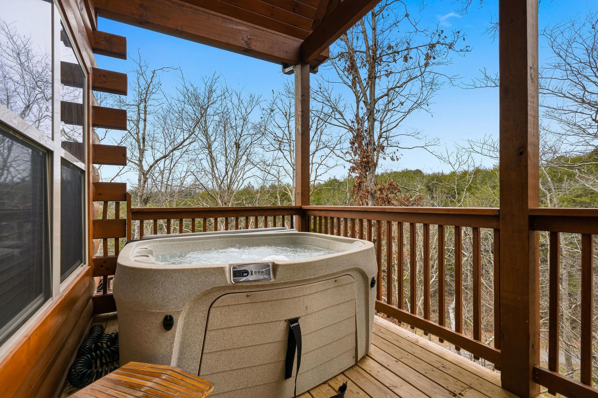 Unwind in your private hot tub on this peaceful covered deck, surrounded by serene treetop views.
