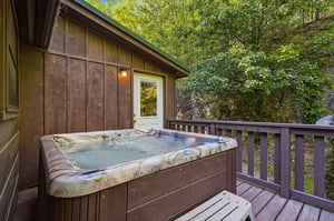 Soak away your worries in your private hot tub surrounded by peaceful forest views.
