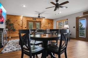 Gather around the handsome dining table with views of nature just beyond. Warm wood accents and inviting seating create the perfect spot for your group meals.