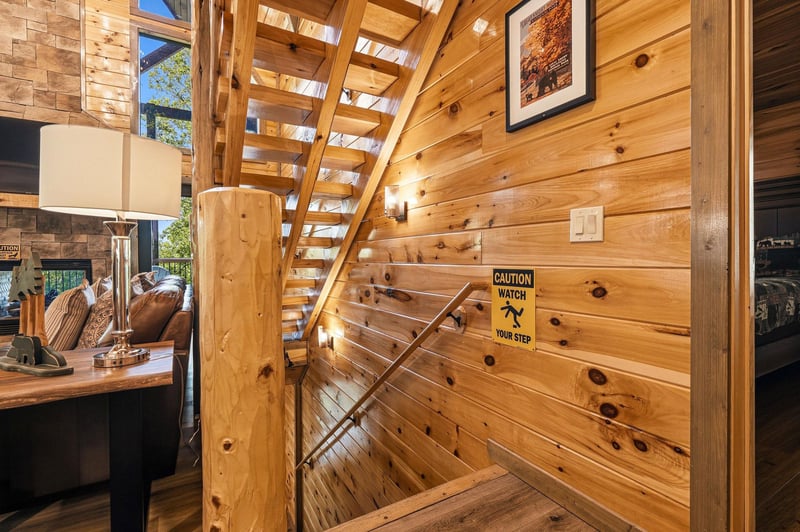 Beautiful wood staircase leads to your private upper level retreat with rustic charm throughout.