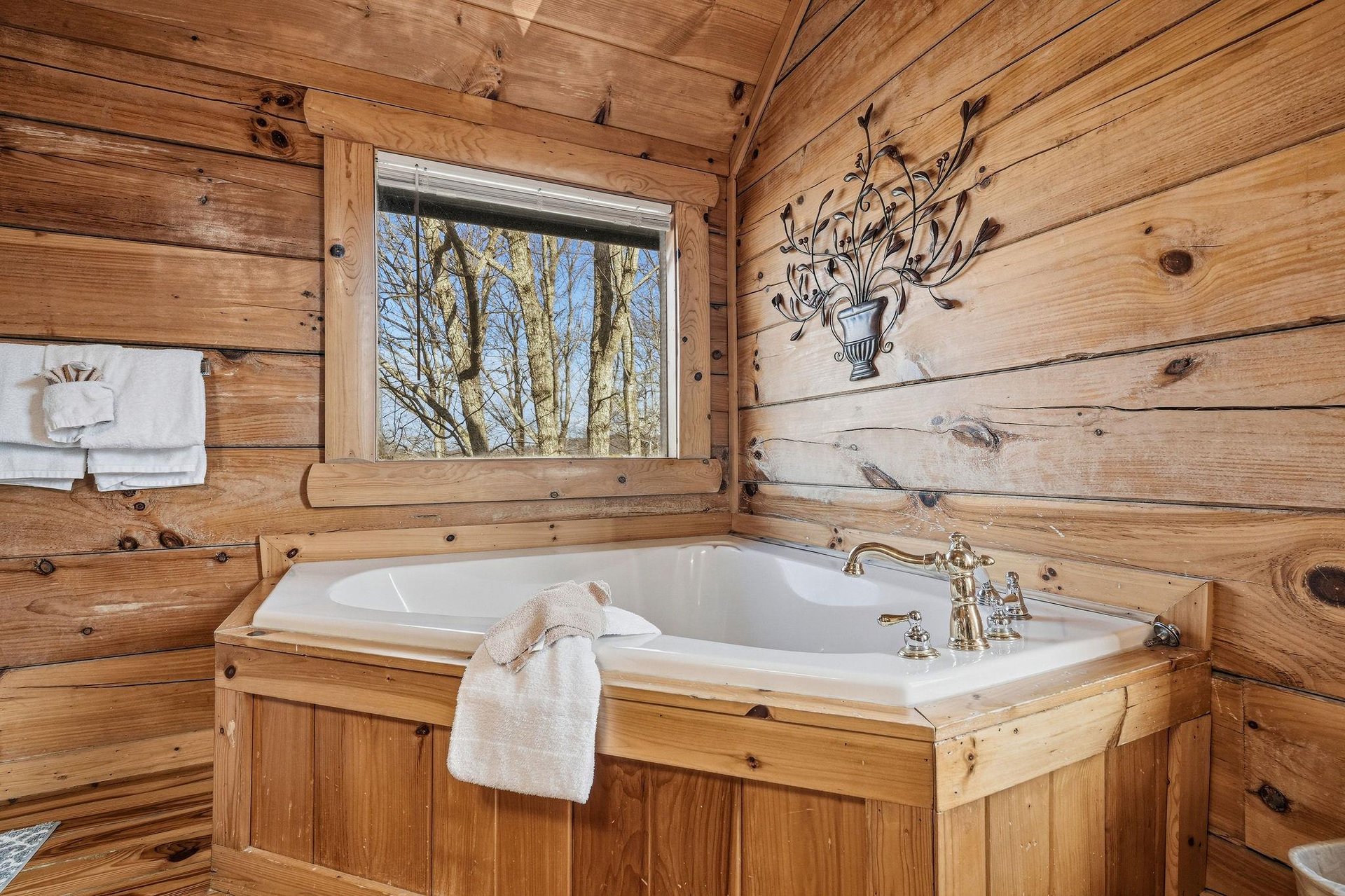 Soak in your private wooden soaking tub while gazing at peaceful forest views through the window.