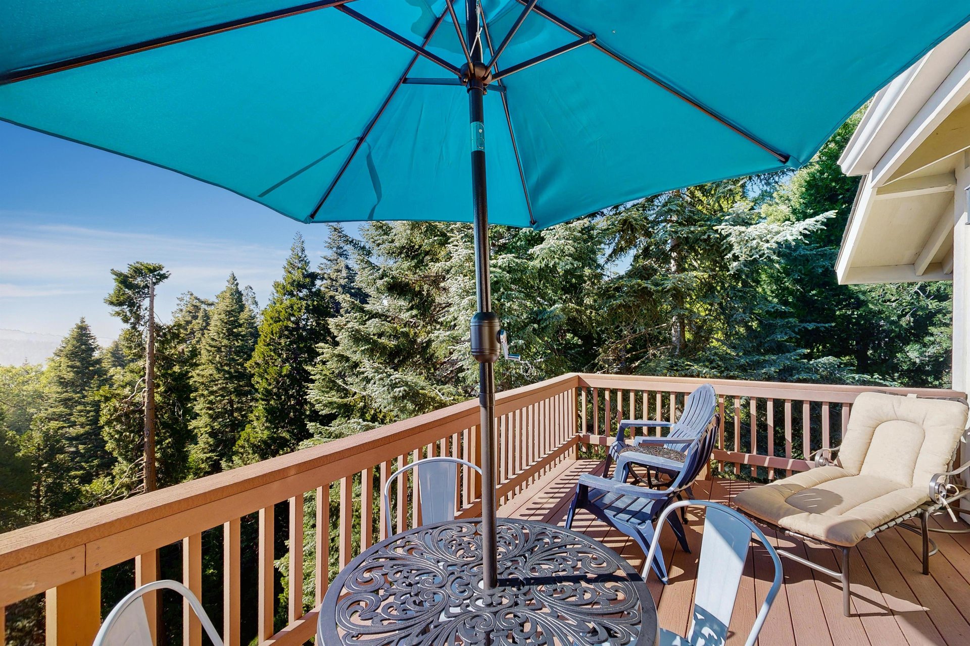 Beautiful, expansive deck with mountain  treetop views, outdoor dining, and BBQ.