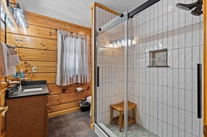 Walkin in shower with seat and single vanity sink