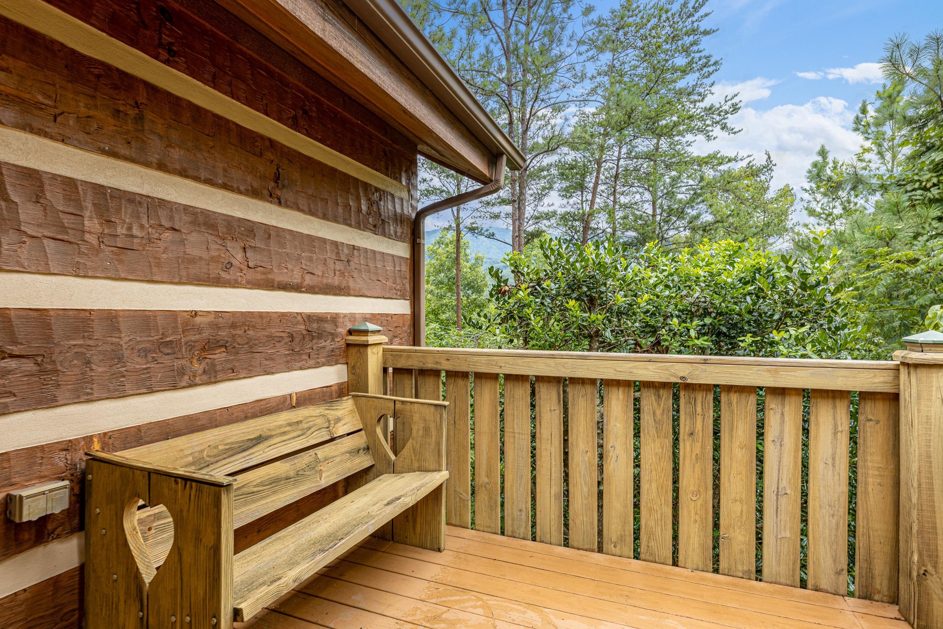 Bench on a deck at Cubs Crib, a 3 bedroom cabin rental located in Gatlinburg