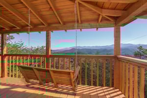 Sway gently in your private porch swing while soaking up breathtaking mountain vistas that stretch endlessly before you.