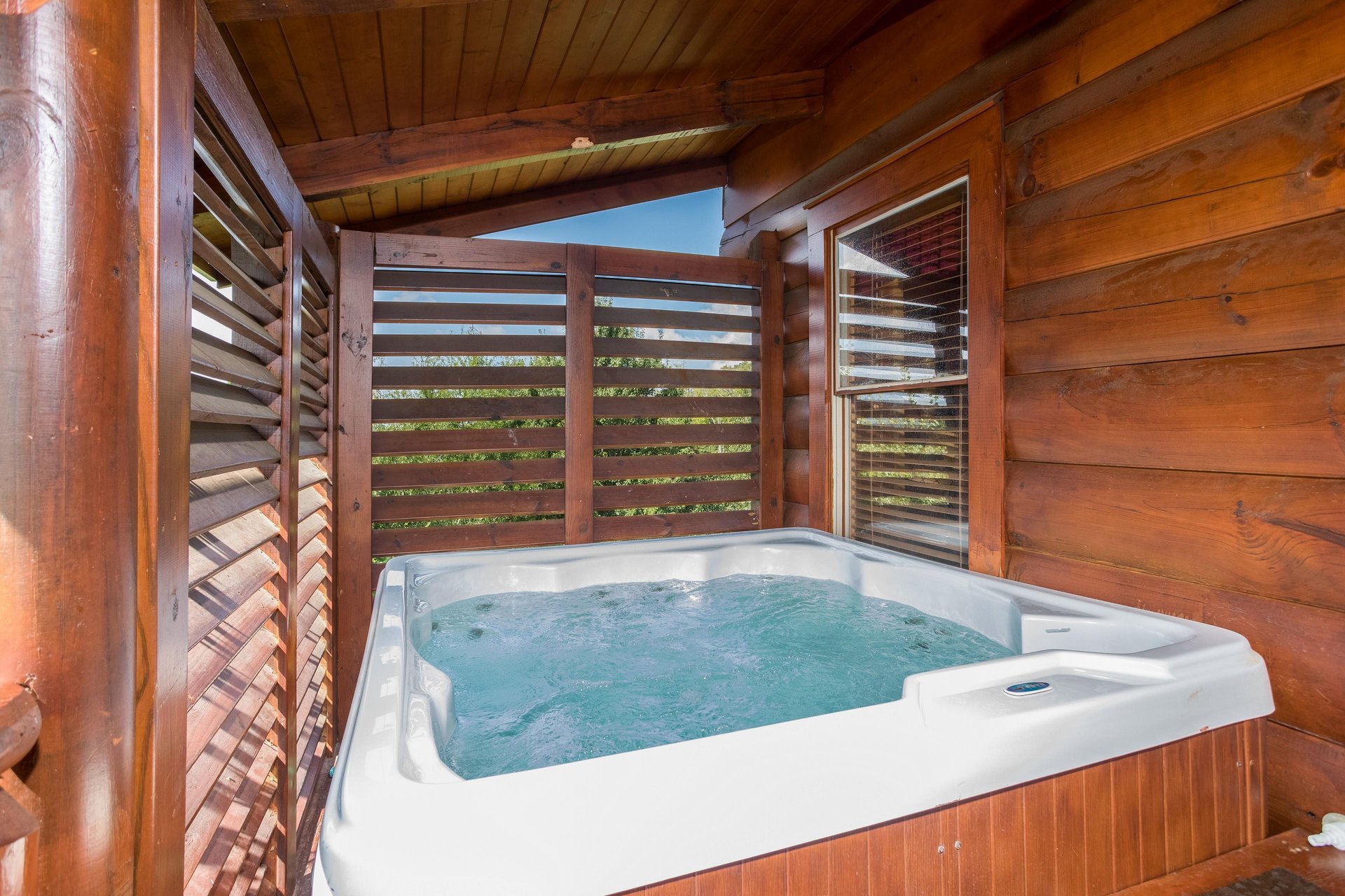 Hot tub on the covered deck at Graceland, a 4bedroom cabin rental located in Pigeon Forge