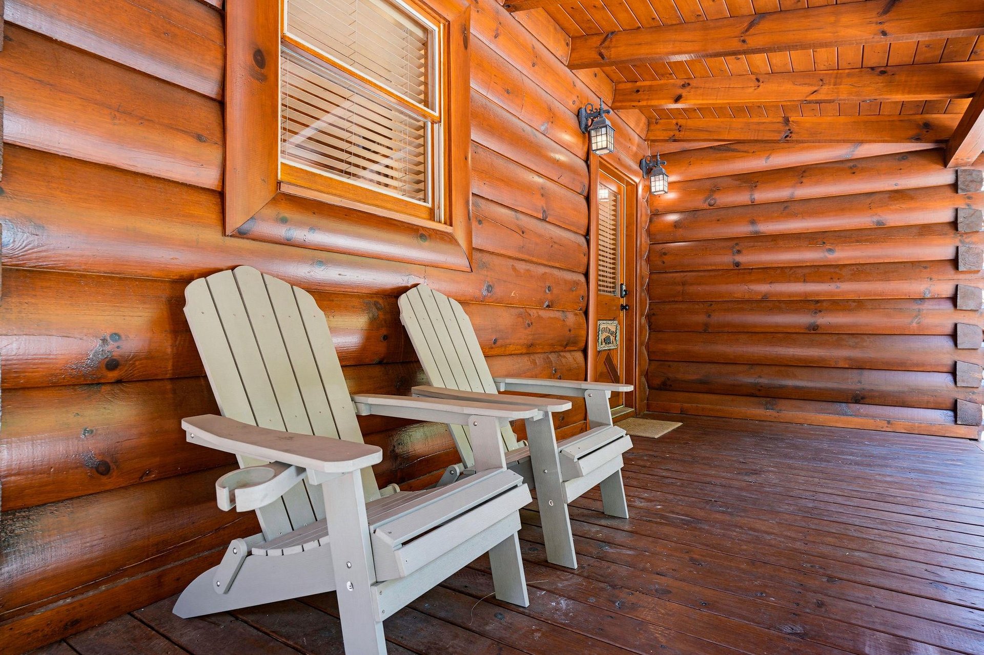 Step onto your private covered porch and sink into classic Adirondack chairs surrounded by warm, natural log walls. A perfect spot to start your morning coffee or unwind at days end.