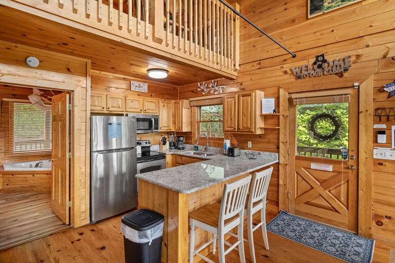 Kitchen with counter and bar chairs