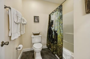 Your private bathroom features a fresh, inviting space with soft towels, a unique naturethemed curtain, and thoughtful touches that make you feel right at home.