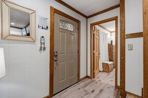 Step into your welcoming entryway where rich wood accents and rustic charm create an inviting first impression for your mountain getaway.