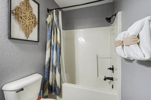 Step into your stylish bathroom featuring a relaxing tubshower combo with fresh towels and decorative touches for your comfort.