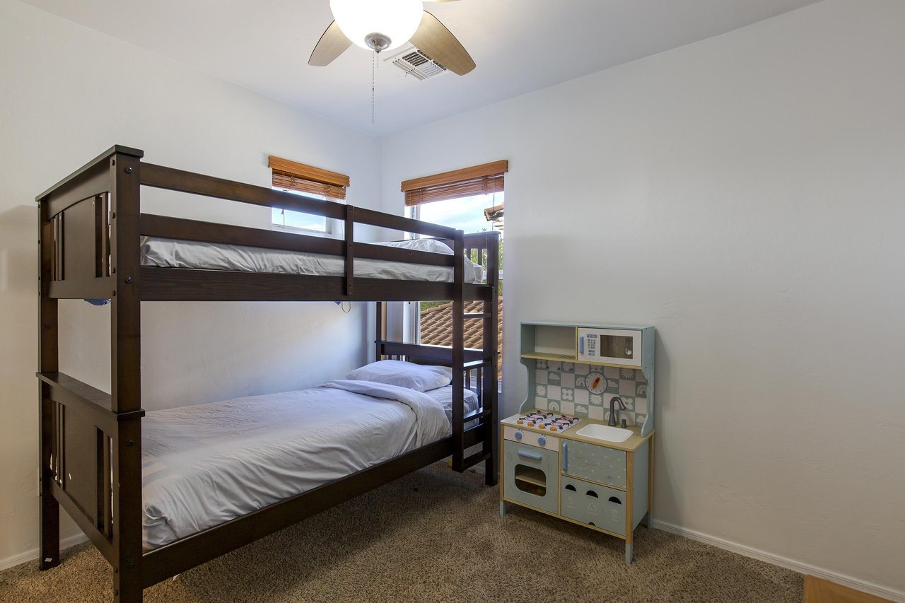 Twin over twin bunk bed and flatscreen TV.