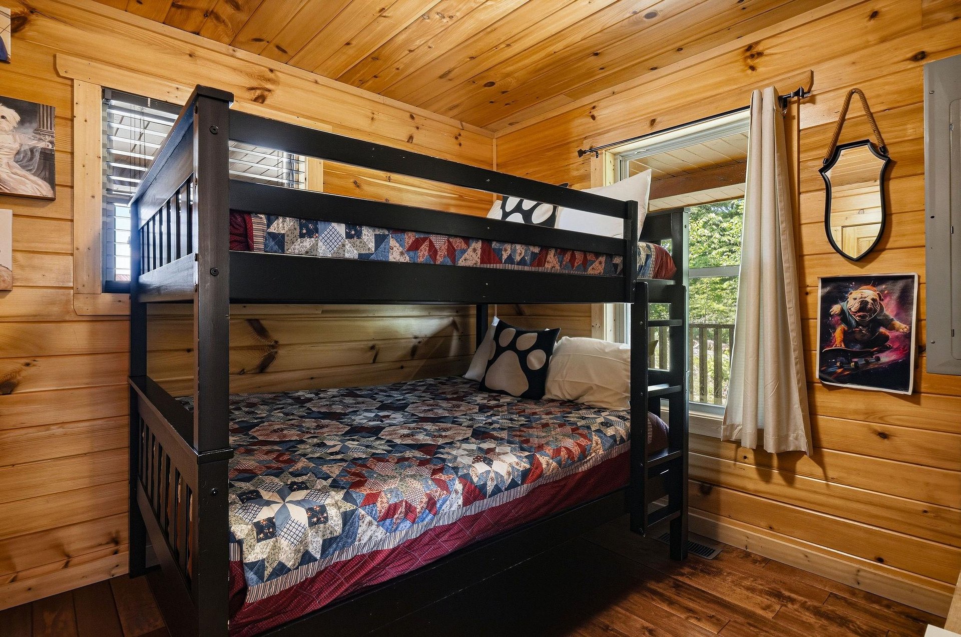 Step into a cozy bedroom where warm wood walls and natural light create a welcoming retreat. Your crew can bunk up comfortably here, surrounded by rustic charm and playful touches that make the space 