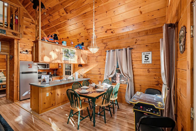 Step into your cozy cabin retreat, where soaring woodpaneled ceilings and an open layout create a warm, welcoming space for meals and memories together.
