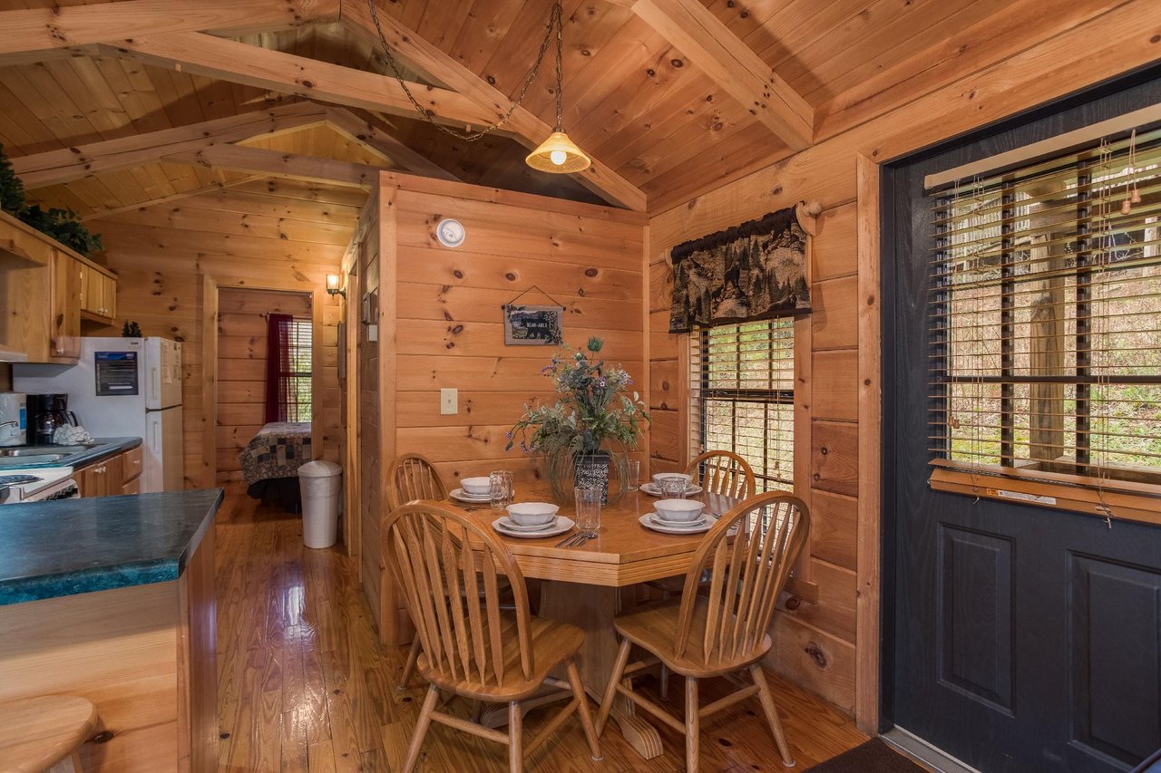 Dining table with seating for four at Boogie Bear, a 1bedroom cabin rental located in Gatlinburg