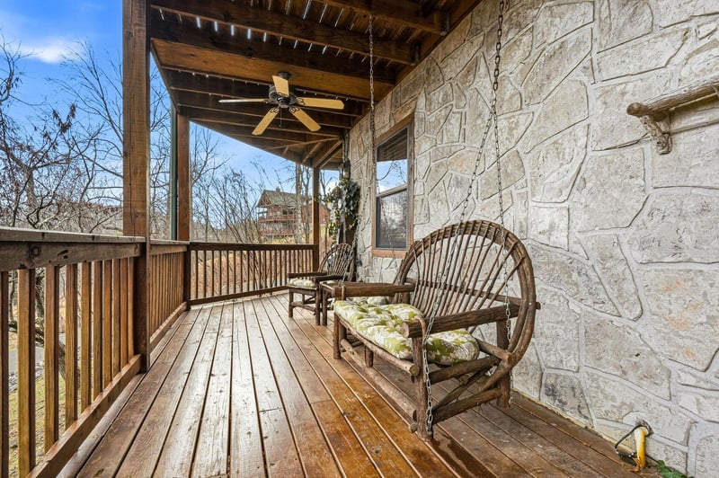 Relax on your private covered porch with rustic charm and peaceful views of the surrounding countryside.