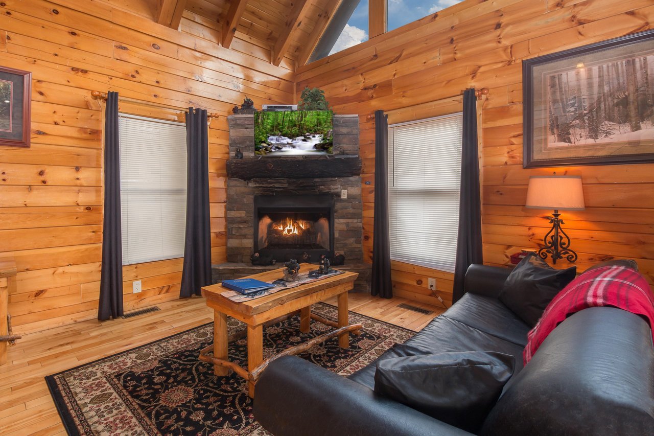 Fireplace and TV in a living room at Country Bears Getaway, a 3bedroom cabin rental located in Gatlinburg