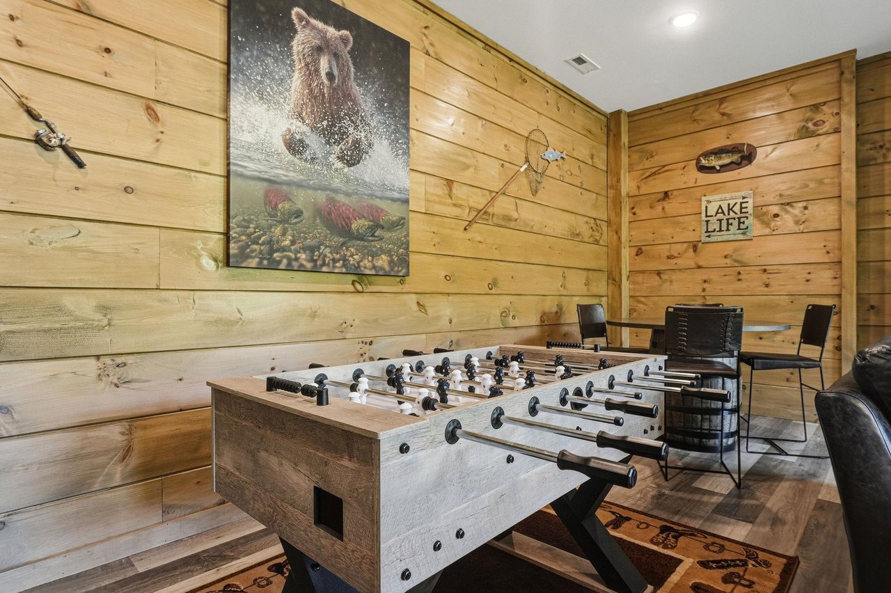 Challenge friends to foosball in your cozy game room, surrounded by rustic wood walls and lakethemed décor.