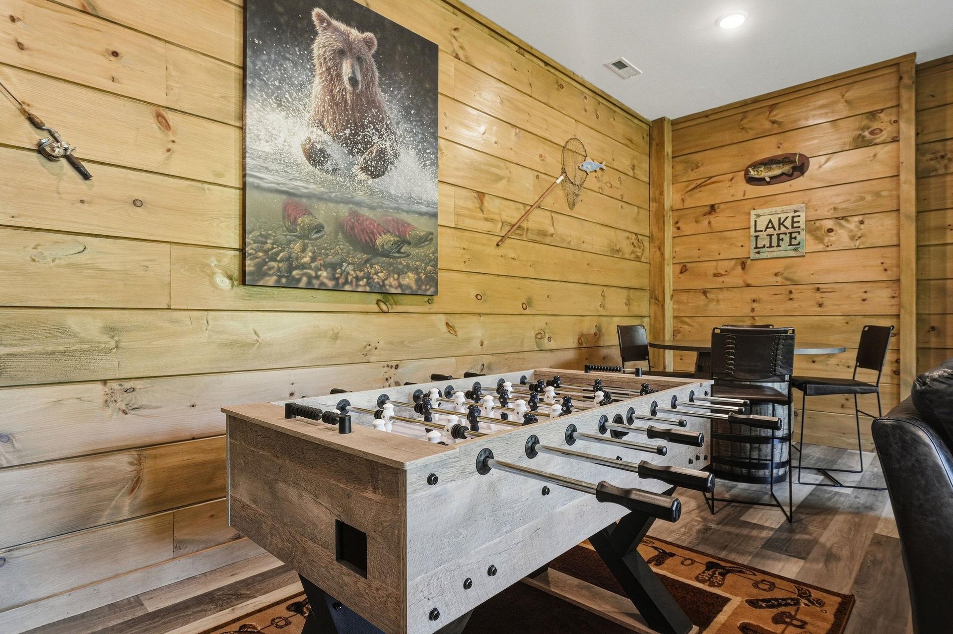 Challenge friends to foosball in your cozy game room, surrounded by rustic wood walls and lakethemed décor.