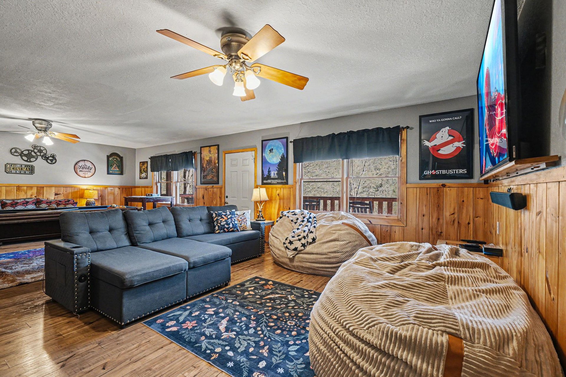 Unwind in your cozy living room featuring plush seating, warm wood accents, and entertainment ready for movie nights.