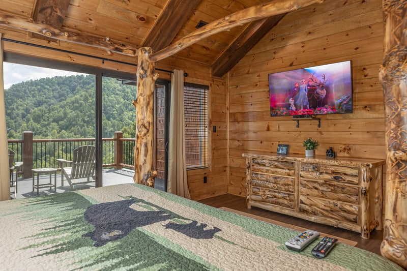 Dresser, TV, and deck access in a bedroom
