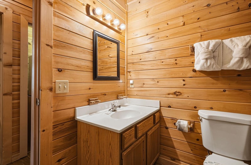 Step into your private retreat where warm knotty pine walls surround fresh linens and a clean, cozy space—your comfort awaits after a day of adventure.