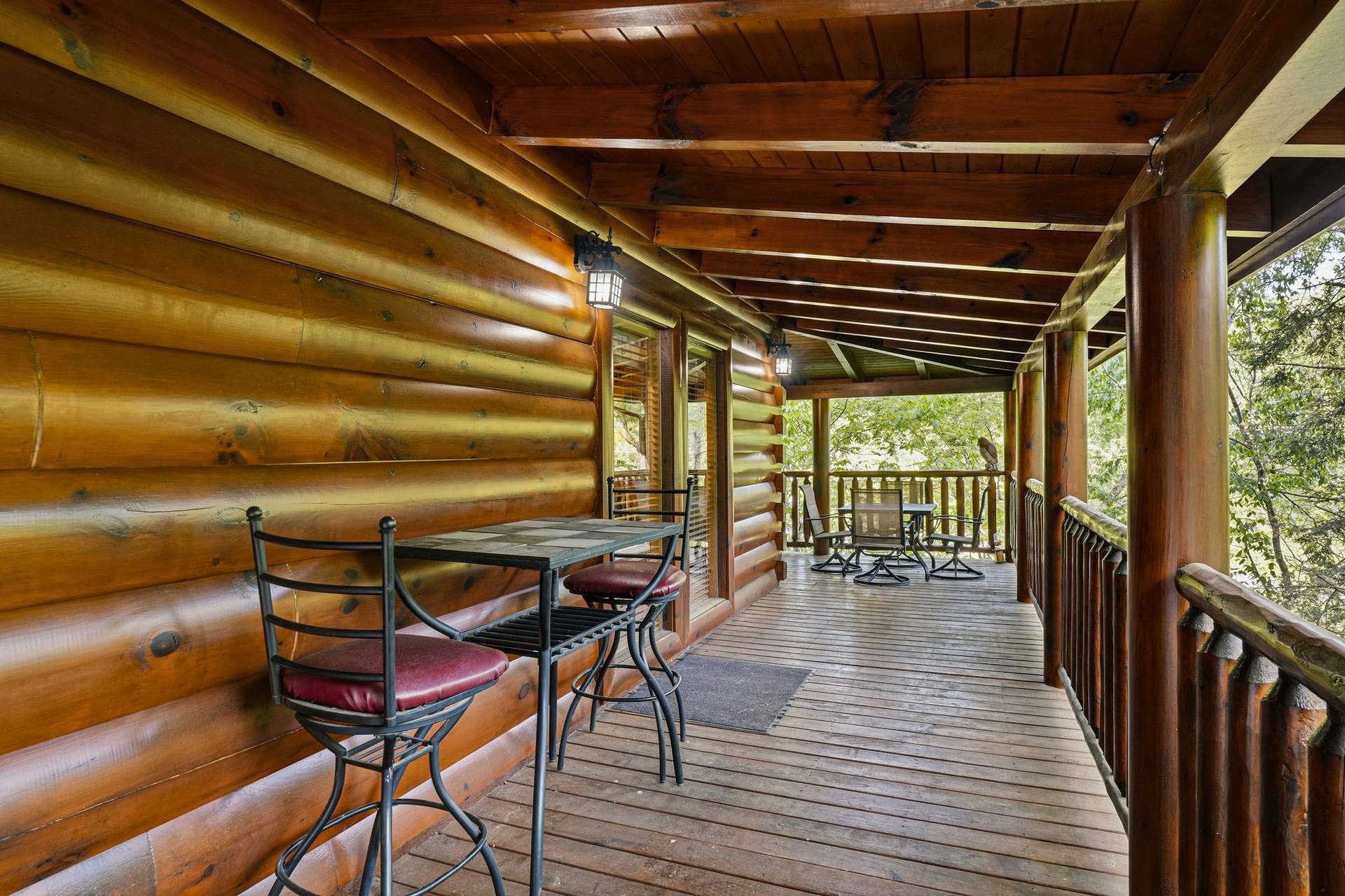 Step onto your private covered deck where rustic charm meets comfort—perfect for morning coffee or evening relaxation surrounded by natures tranquil embrace.