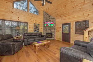 Vaulted living room with fireplace and TV at Bessy Bears Cabin, a 2 bedroom cabin rental located inGatlinburg