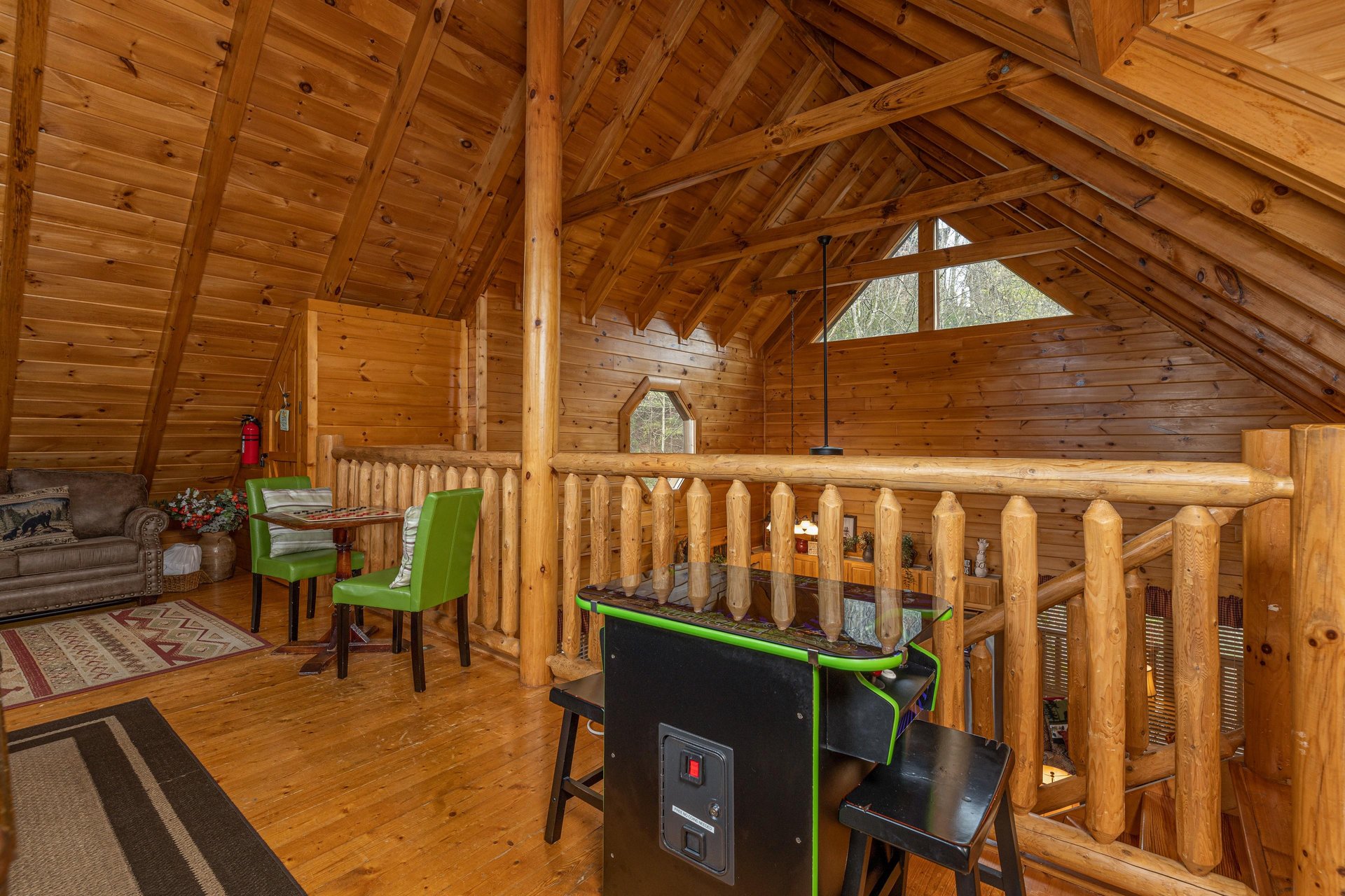 Arcade game in the loft at Absolutely Wonderful, a 2 bedroom cabin rental located in Pigeon Forge