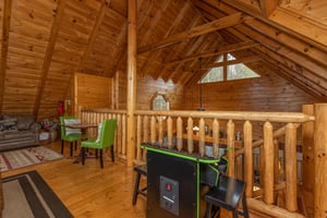 Arcade game in the loft at Absolutely Wonderful, a 2 bedroom cabin rental located in Pigeon Forge