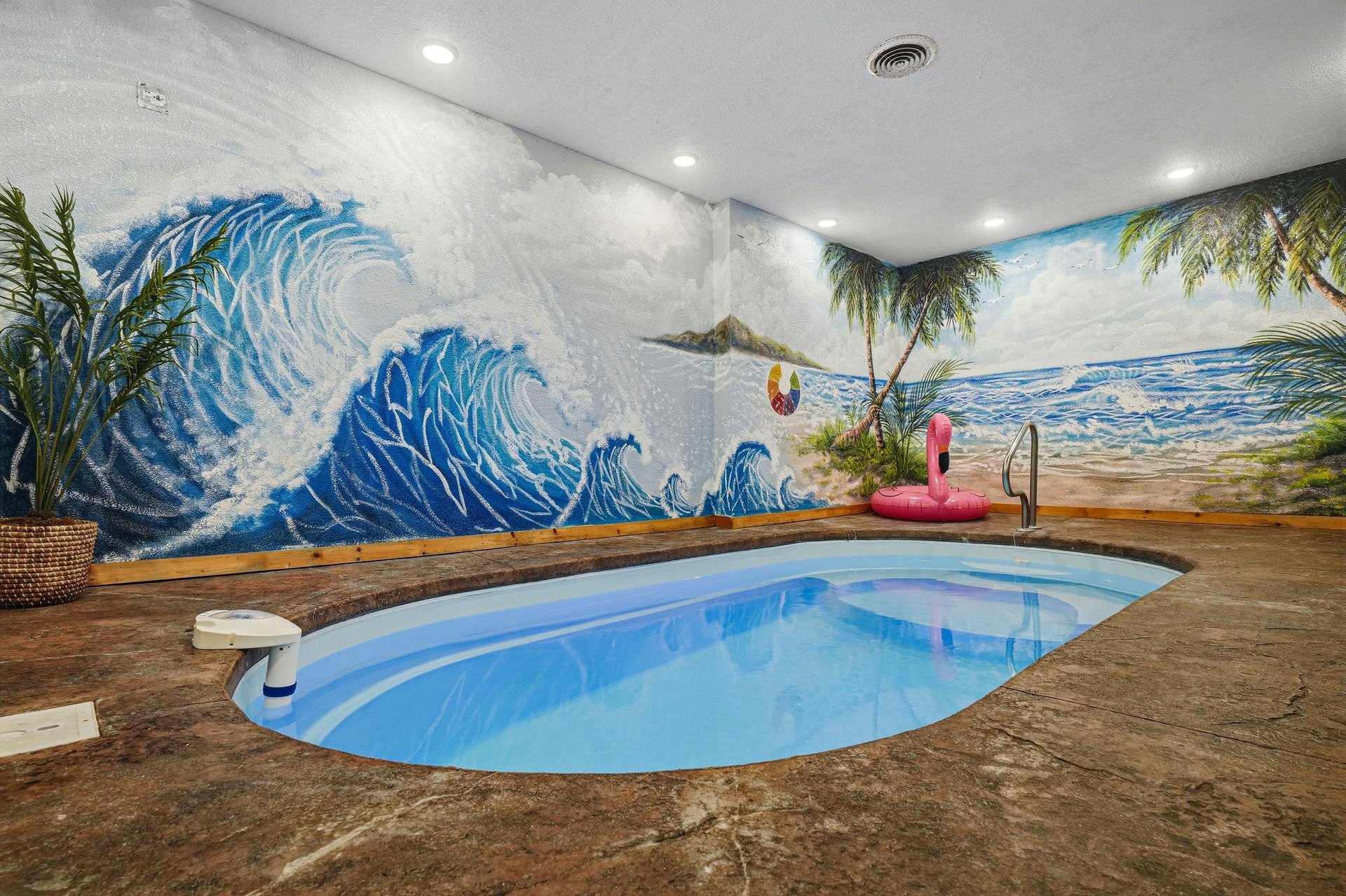 Your own private indoor oasis awaits with a sparkling plunge pool surrounded by vibrant tropical murals, colorful floaties, and island vibes that bring the beach right to you.