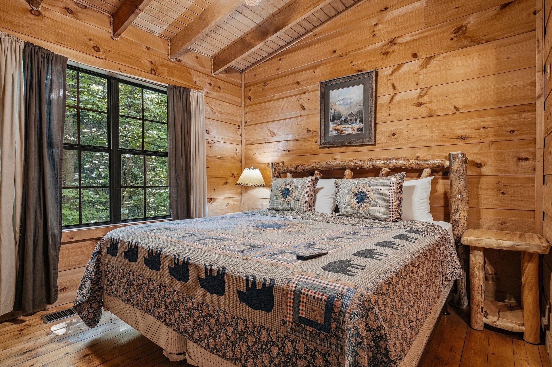 Sink into the handcrafted log bed surrounded by warm pine walls and wake to forest views through your charming window. Cozy quilts and rustic touches create your perfect mountain retreat.