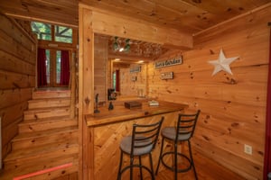 Bar on the lower floor at Logans Smoky Den, a 2 bedroom cabin rental located in Pigeon Forge