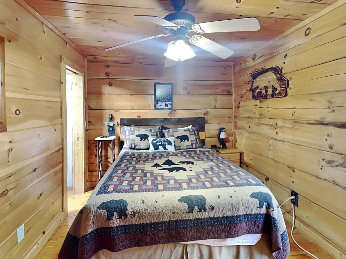 Sink into cozy comfort in your own rustic cabin retreat, where warm wood tones and charming bearthemed décor set the scene for peaceful mountain dreams.