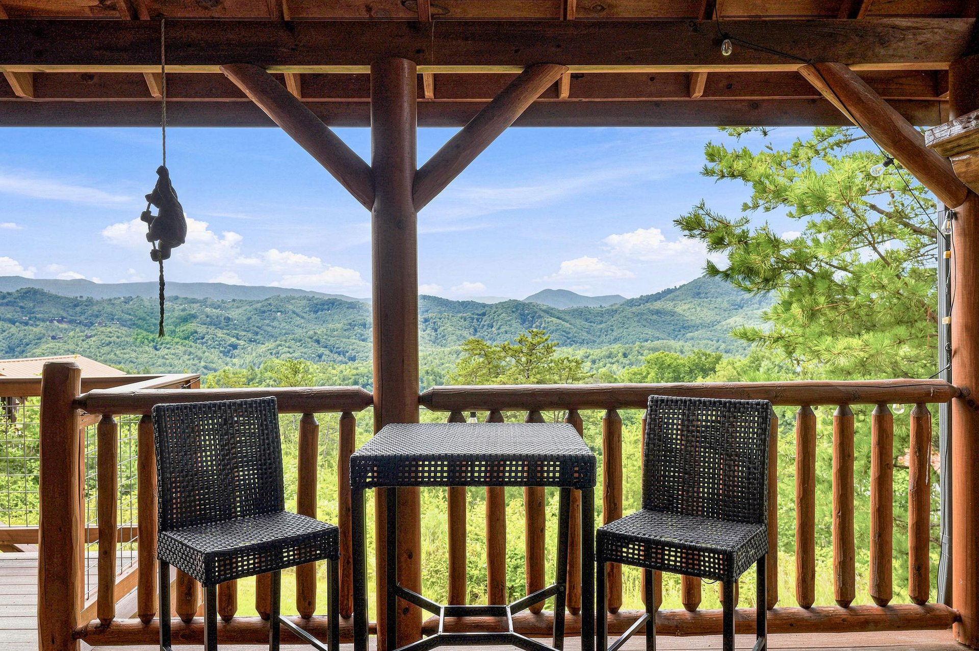 Sip your morning coffee from this covered terrace while gazing out at lush mountain ridges stretching to the horizon—your peaceful retreat among the trees.