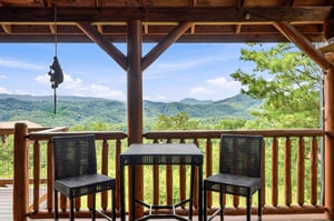Sip your morning coffee from this covered terrace while gazing out at lush mountain ridges stretching to the horizon—your peaceful retreat among the trees.
