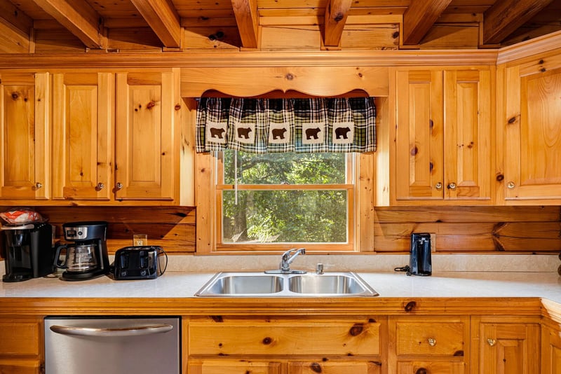 Warm wood cabinets, modern appliances, and a peaceful view through the window make your morning coffee feel like a retreat.