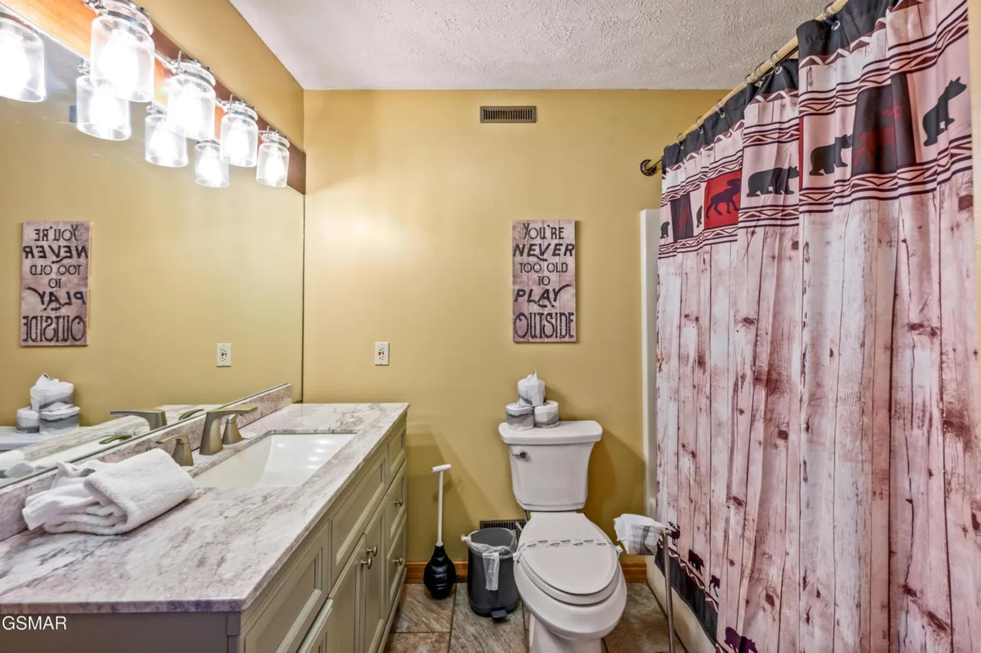Step into your rusticchic bathroom featuring dual vanities, playful decor, and thoughtful touches that make your morning routine feel like a spa experience.