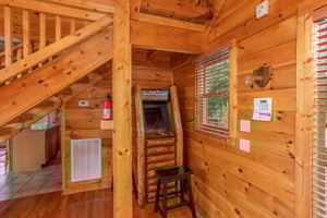 Arcade game in the living room at Four Seasons Lodge, a 3bedroom cabin rental located in Pigeon Forge