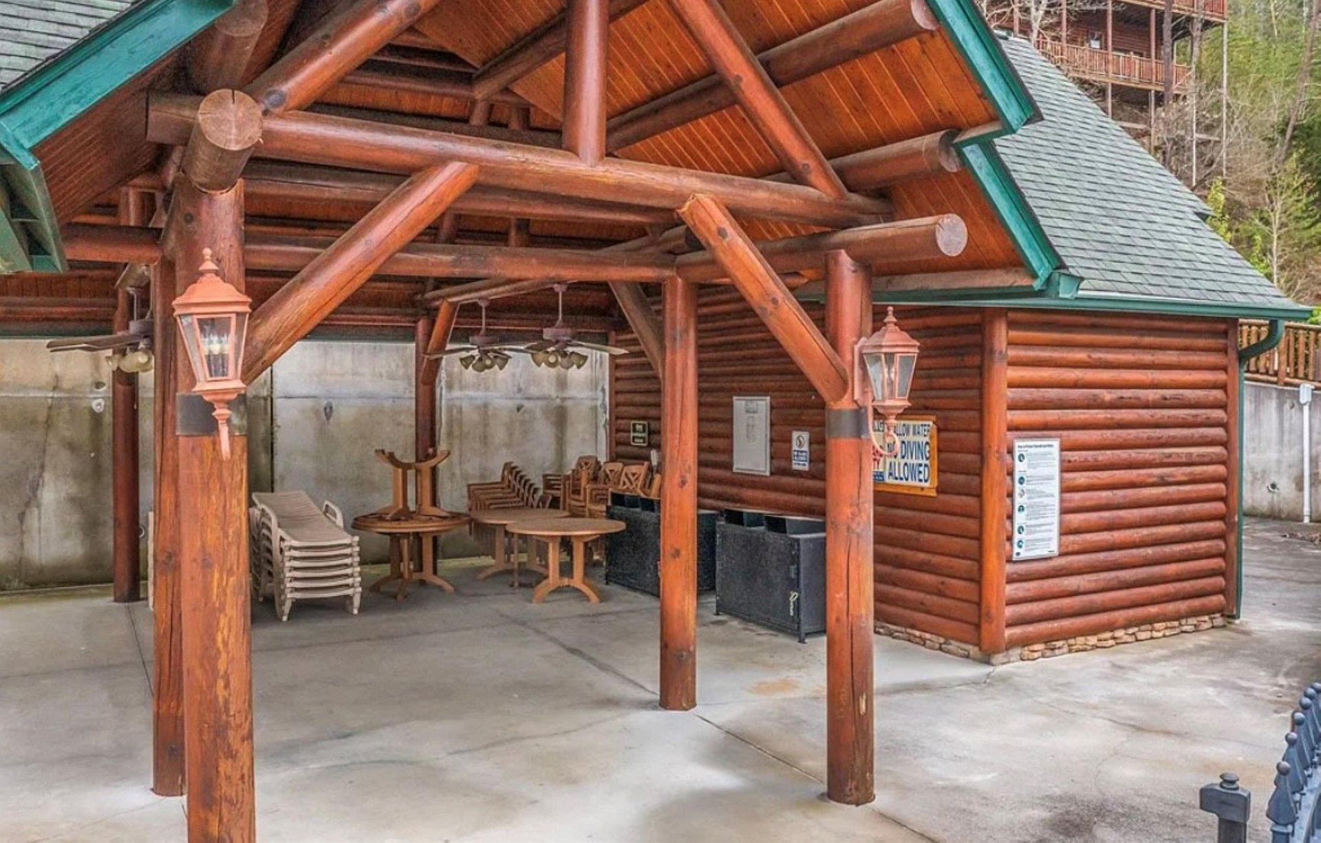 Gather under this charming log pavilion where rustic wooden beams frame your outdoor dining and grilling adventures.
