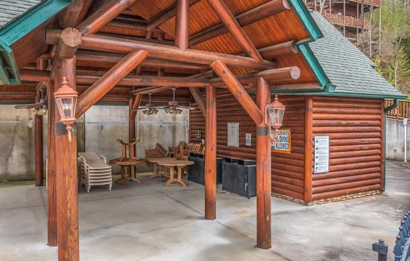 Gather under this charming log pavilion where rustic wooden beams frame your outdoor dining and grilling adventures.