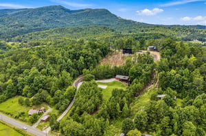 Nestled among lush forest and rolling mountains, the property offers peaceful seclusion in a stunning natural setting.