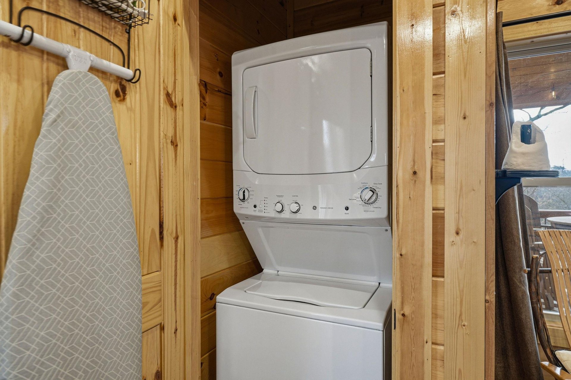 Your own washer and dryer await in this cozy woodpaneled laundry nook, with an ironing board ready for those freshpressed looks.