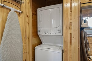 Your own washer and dryer await in this cozy woodpaneled laundry nook, with an ironing board ready for those freshpressed looks.